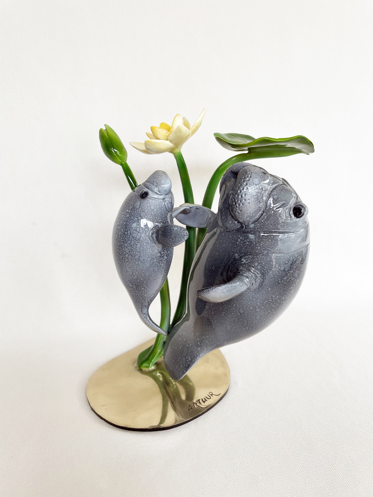 Signed, limited edition bronze Manatees sculpture